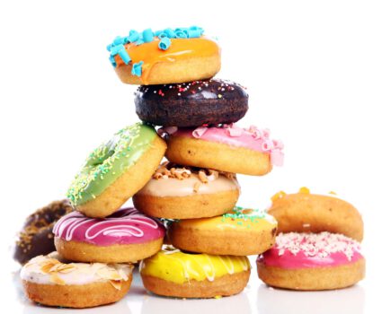 Colorful and tasty donuts on white background